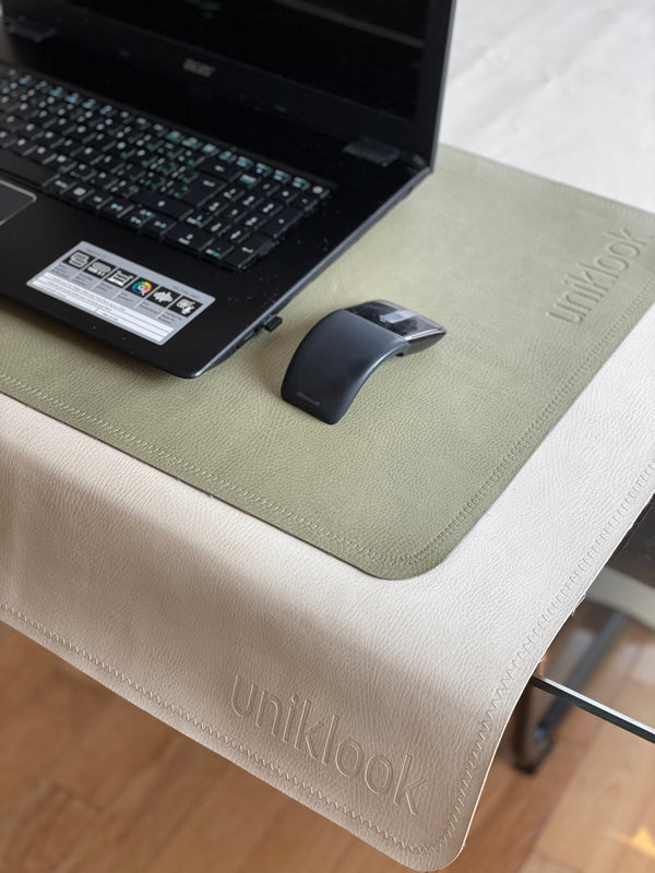 a desk mat green with a computer and a mouse
