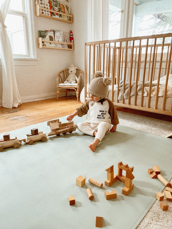Uniklook sage green and dawn blue maxi 54"x54" leather drop cloth used as a playmat in kids room