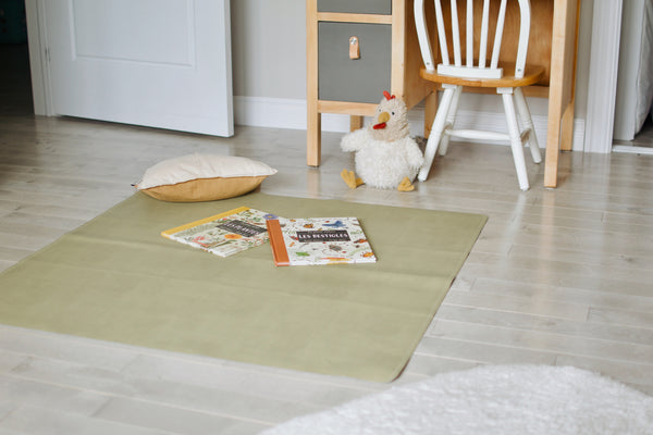 Uniklook hunter green vegan leather med mat used as a playmat in a kids room