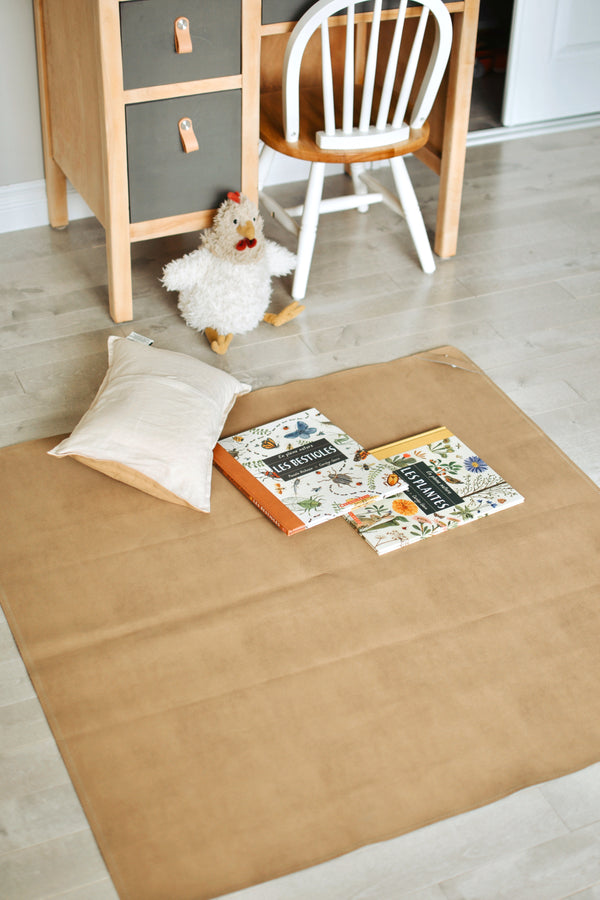 Uniklook hunter green and tan leaher mat showing the tan side used as a playmat