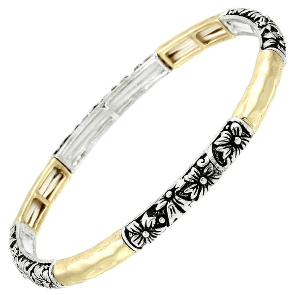 Two-tone gold and silver bracelet with intricate black patterns on a white background