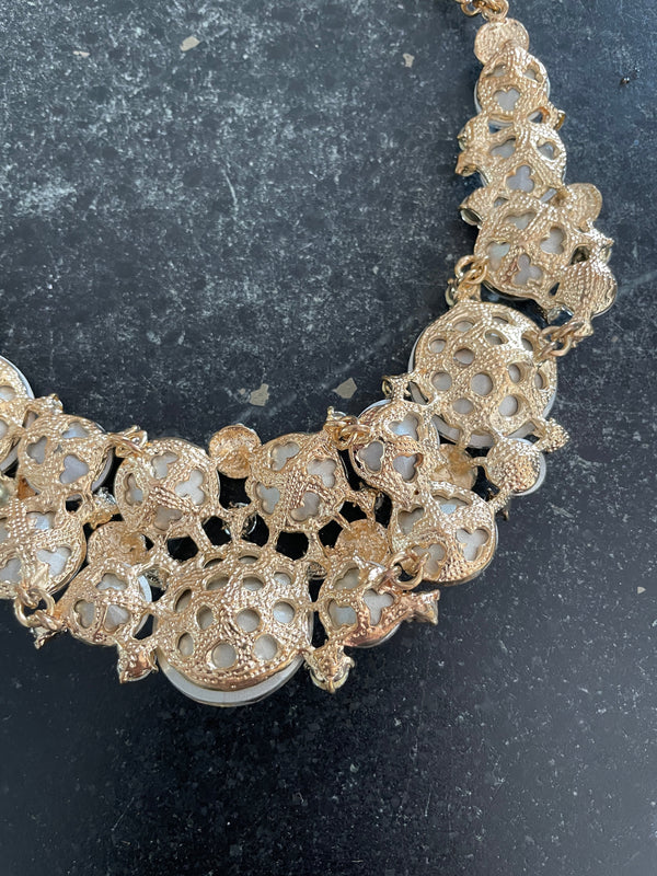 Gold bracelet with intricate design on a dark background
