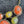 Charger l'image dans la galerie, A close-up of a statement necklace with irregular orange and yellow-green cabochon stones in ornate silver-tone settings, shown on a dark textured surface with matching drop earrings partially visible at the top left.
