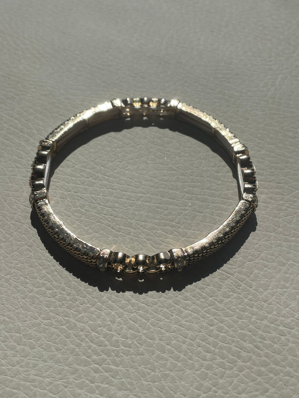 Silver ring with textured design on a gray background