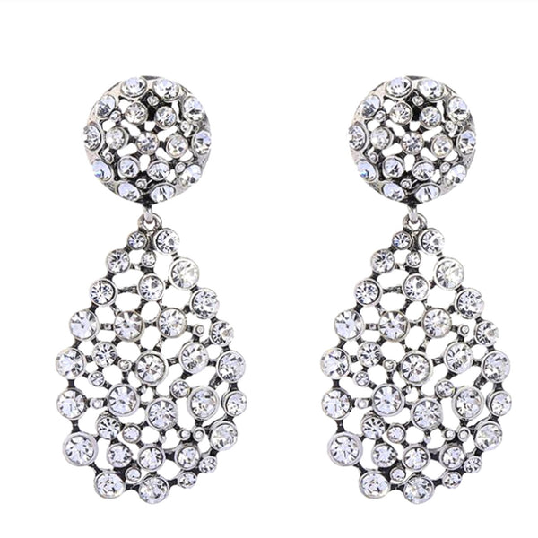 Pair of silver earrings with crystal embellishments on a white background