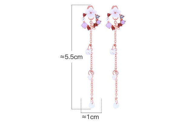 Pair of long earrings with floral designs and measurements on a white background