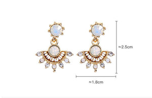 Pair of gold and white gemstone earrings with measurements on a white background