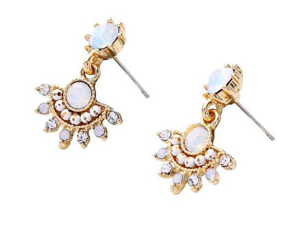 Gold earrings with opal stones on a white background