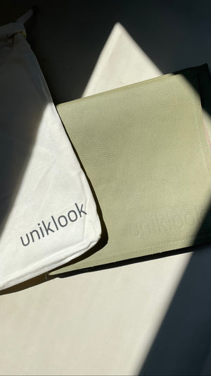 Uniklook vegan leather hunter green med showing the canva bag that it comes in.