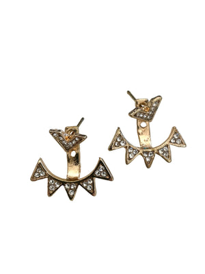 Anchor-shaped earrings with gemstones on a light gray background