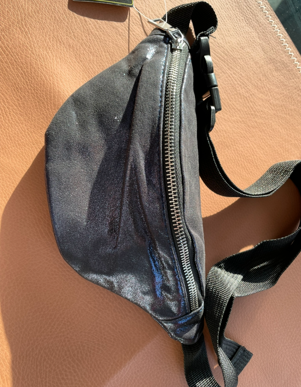 Blue waist bag on a beige surface