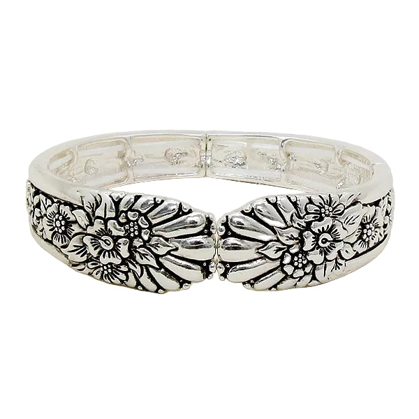 Silver bracelet with floral patterns on a white background