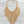 Load image into Gallery viewer, A gold-toned statement necklace with a textured, scale-like fringe design, displayed on a dark slate surface.

