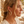 Load image into Gallery viewer, Woman wearing gold hoop earrings with a blurred outdoor background
