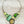 Charger l'image dans la galerie, Necklace with green and silver design on a dark surface
