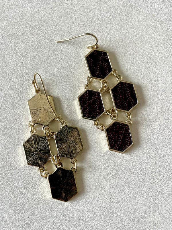Pair of geometric earrings on a light gray background