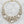 Charger l'image dans la galerie, Gold necklace with large crystal beads on a dark surface
