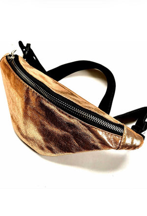 Gold metallic fanny pack with a black zipper on a white background