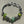 Load image into Gallery viewer, Beaded bracelet with green and silver beads on a textured surface

