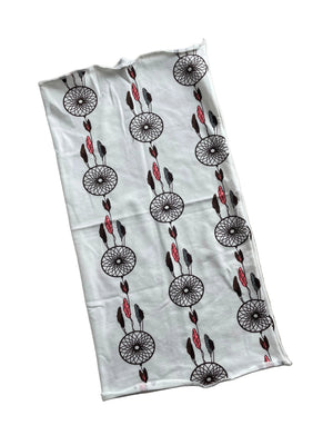 White fabric with black and red pattern on a beige surface