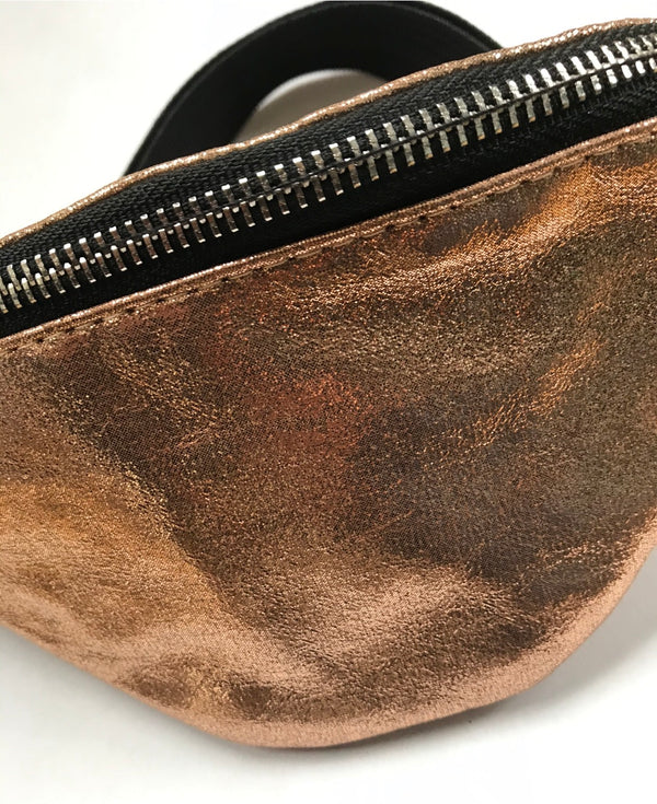 Brown leather fanny pack with a zipper on a white background