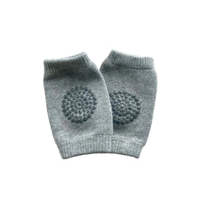 Pair of gray baby leggings with textured design on a light gray background