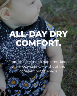 Baby wearing a floral outfit with text about all-day dry comfort.