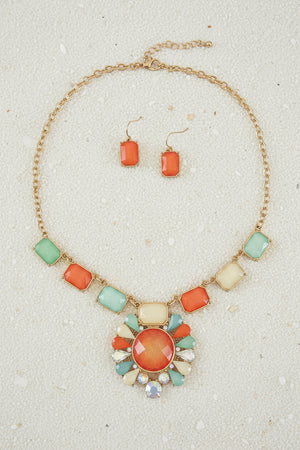 Jewelry set with necklace and earrings on a dark surface