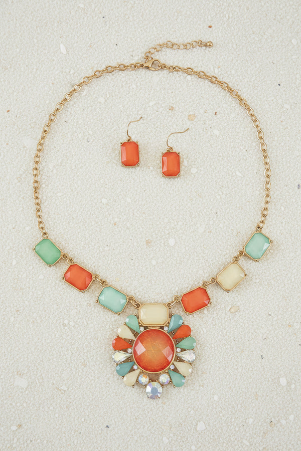 Jewelry set with necklace and earrings on a dark surface