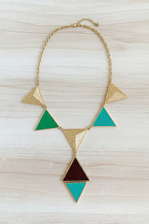 Geometric necklace with triangles on a dark surface