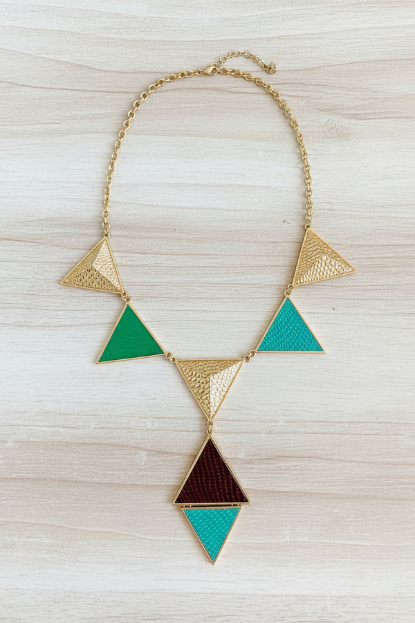Geometric necklace with triangles on a dark surface