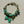 Load image into Gallery viewer, Bracelet with turquoise beads and a bow charm on a light gray background
