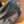 Load image into Gallery viewer, Silver fanny pack on a beige surface
