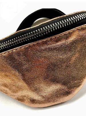 Brown leather fanny pack with a black zipper on a white background