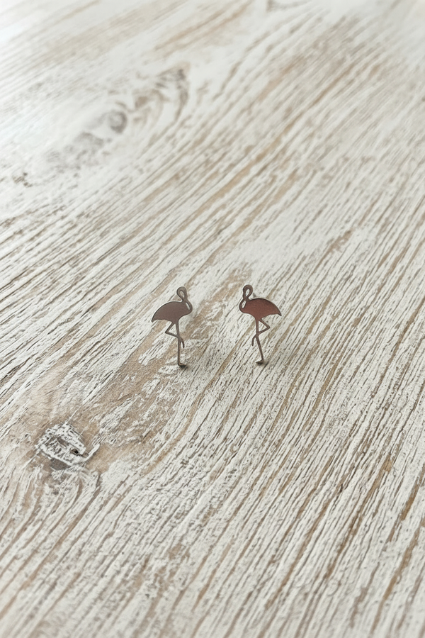 Flamingo earrings on a 'The One' branded card with 'Designed in U.S.A.' text, on a wooden surface.
