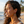 Charger l'image dans la galerie, Woman with curly hair and earrings on a beach
