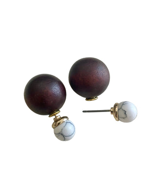 Wooden knobs with marble accents on a light gray background