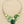 Charger l'image dans la galerie, Necklace with green and silver design on a dark surface

