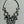 Load image into Gallery viewer, A silver-toned statement necklace featuring multiple circular and oval links, some adorned with clear faceted rhinestones, laid flat on a light gray background.
