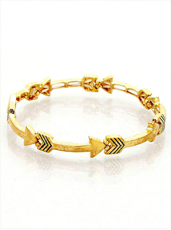 Gold bracelet with arrow designs on a white background