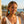 Load image into Gallery viewer, Woman wearing blue earrings with a scenic background
