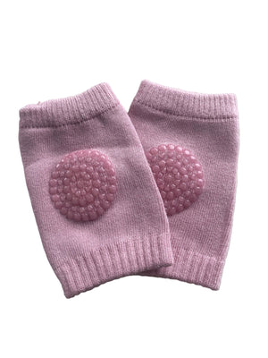 Pair of pink knee pads with textured pads on a light gray background