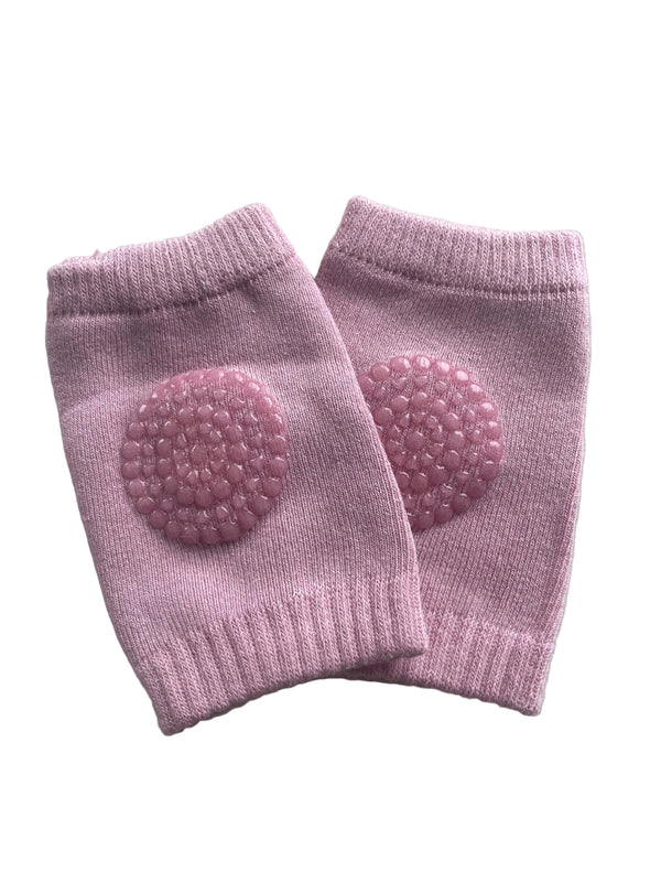 Pair of pink knee pads with textured pads on a light gray background