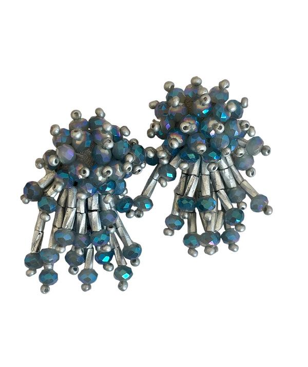 Pair of silver and blue beaded earrings on a white background