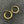 Load image into Gallery viewer, Gold hoop earrings with embedded stones on a dark textured surface
