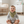 Load image into Gallery viewer, Baby sitting on a rug in a nursery wearing a green bib and gray outfit.
