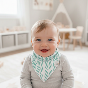 Baby wearing a green and white striped bib in a bright room.