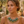 Load image into Gallery viewer, Woman wearing a green necklace outdoors with a stone wall and plants in the background

