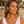 Load image into Gallery viewer, Woman wearing colorful tassel earrings on a beach
