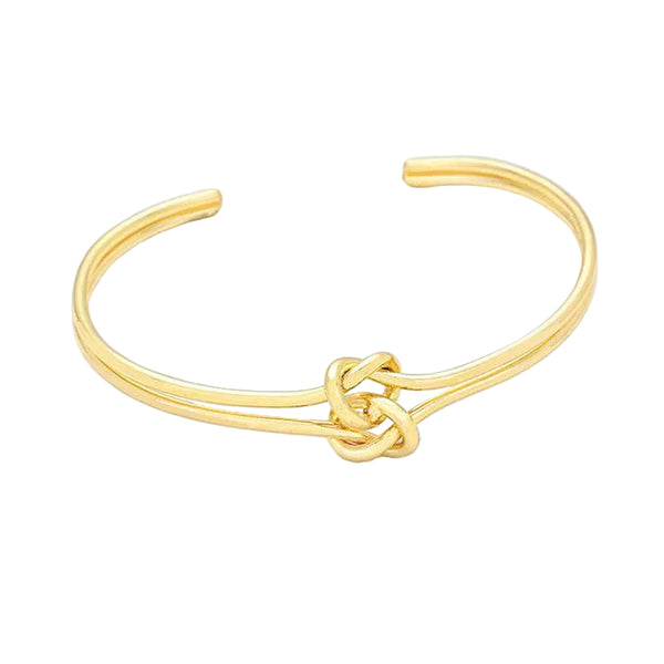 Gold bracelet with a knot design on a light gray background